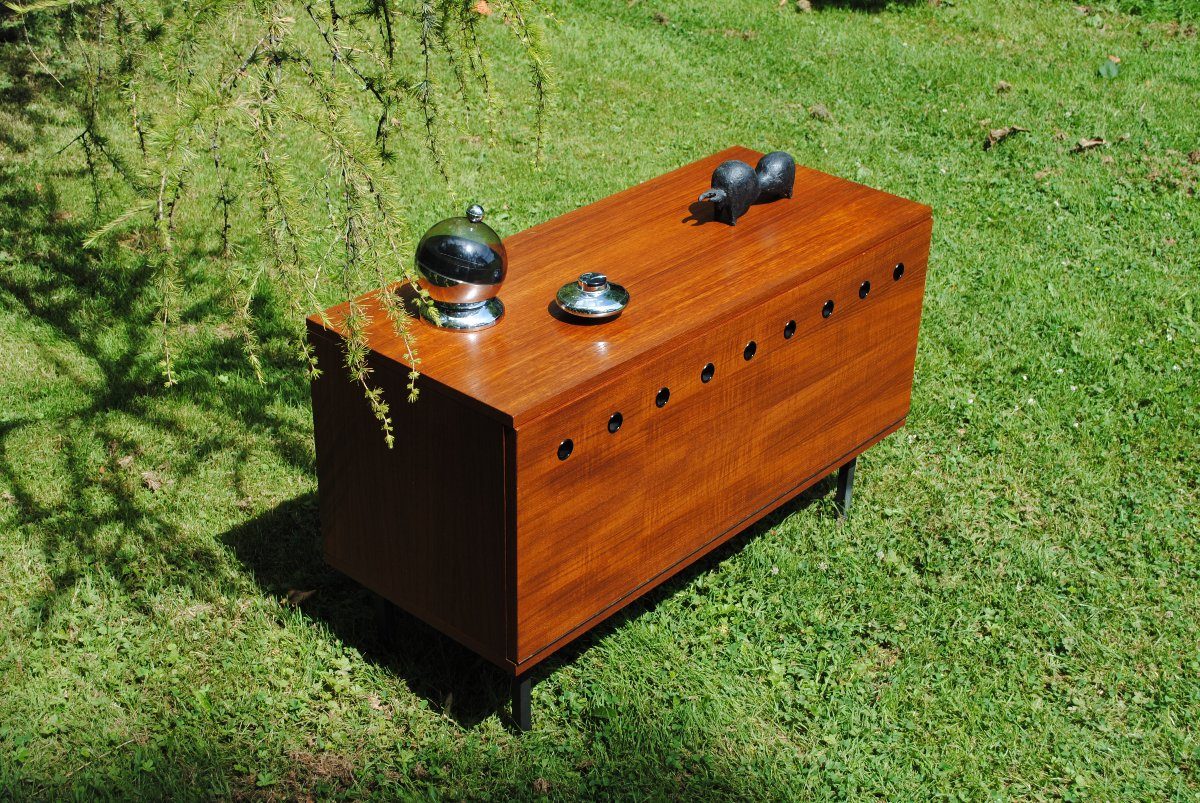 Mid-century wooden cabinet photographed outdoors on grass